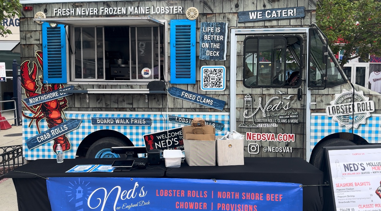 Ned's New England Deck Mollusk Mobile truck at an outdoor event with order counter